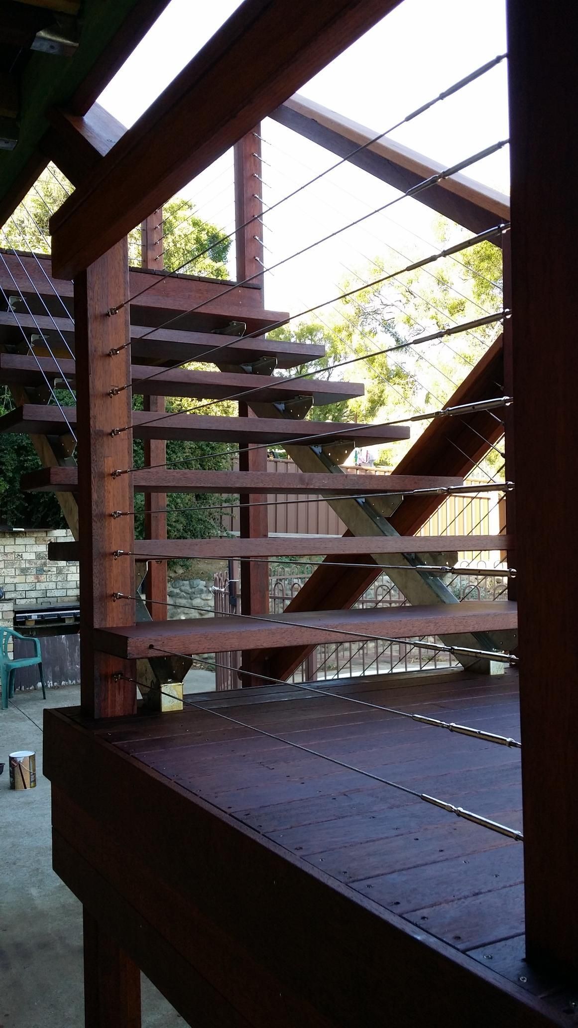 A Wooden Staircase With a Metal Railing on a Deck — Kareela Constructions In Tamworth, NSW