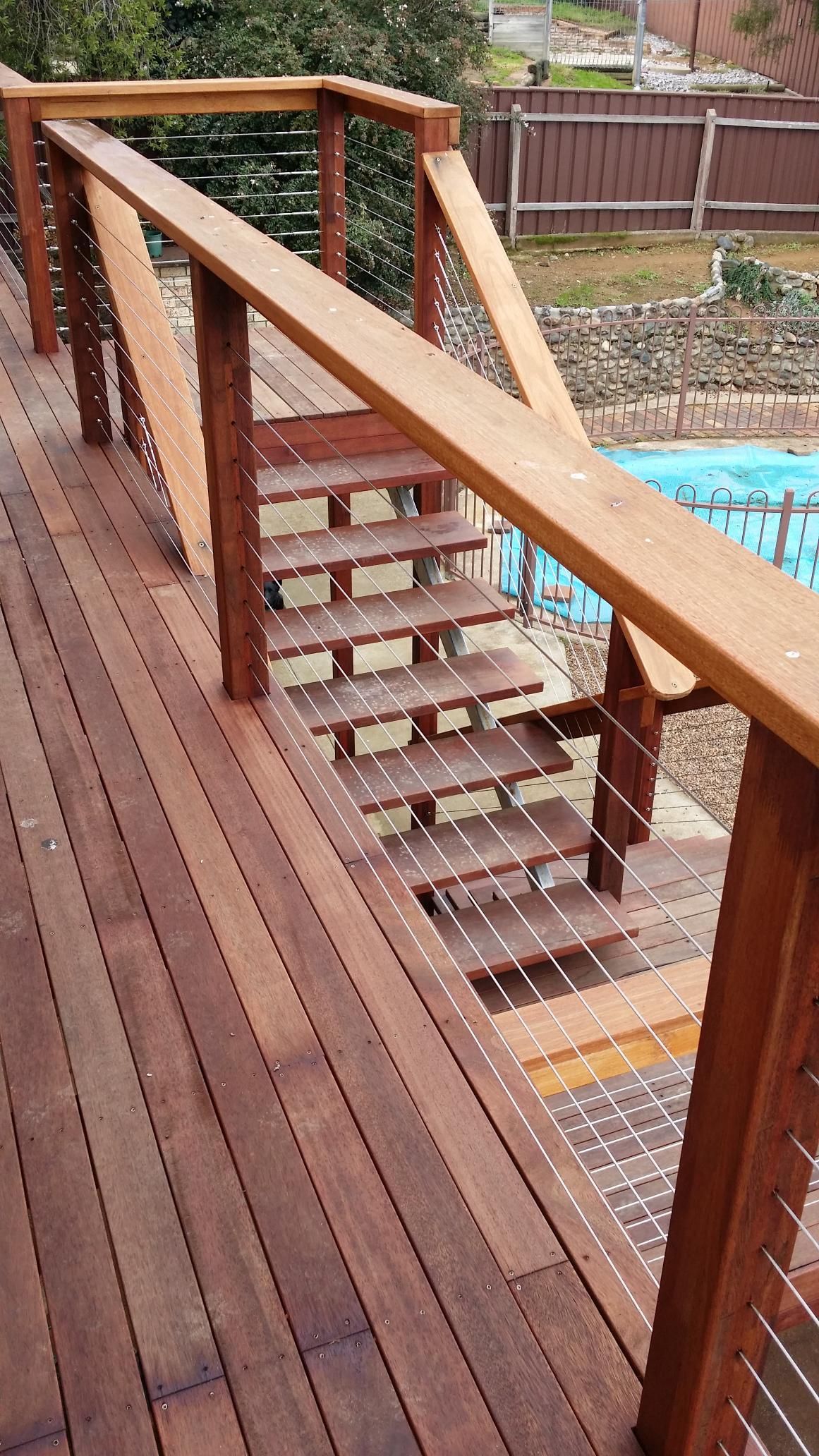 A Wooden Deck With Stairs Leading Up to a Pool — Kareela Constructions In Tamworth, NSW
