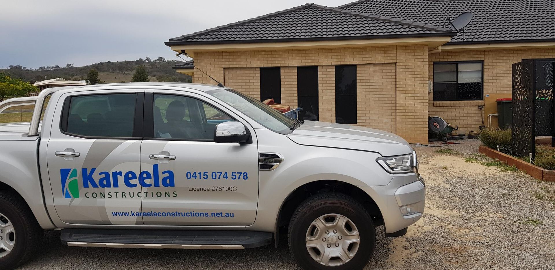 A White Truck With the Word Kareela on the Side is Parked in Front of a Brick House — Kareela Constructions In Tamworth, NSW