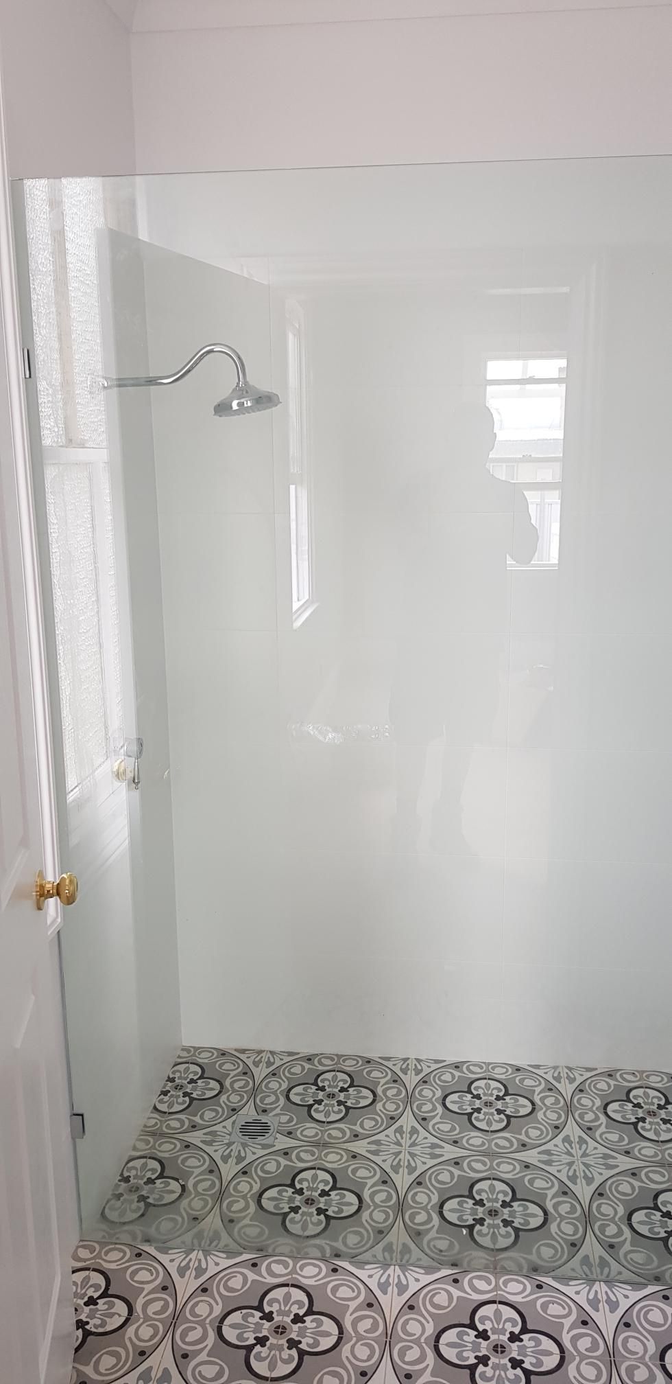 A Bathroom With a Walk in Shower and a Tiled Floor — Kareela Constructions In Tamworth, NSW
