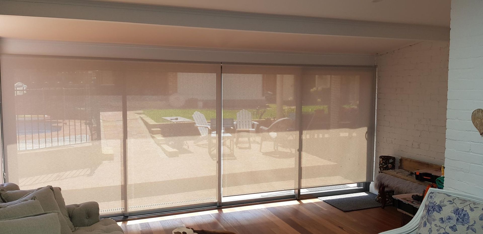 A Living Room With Sliding Glass Doors and Blinds on the Windows — Kareela Constructions In Tamworth, NSW