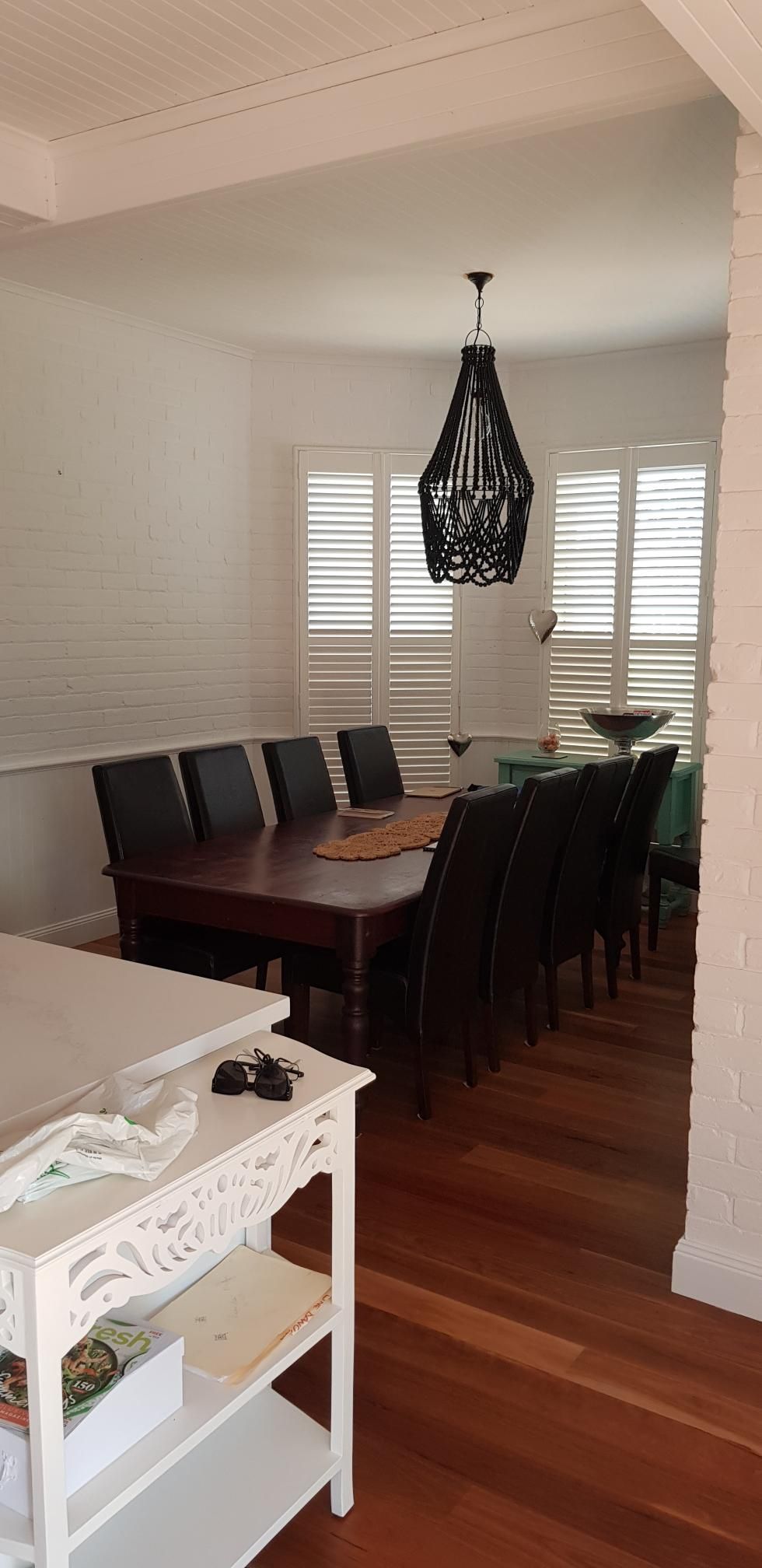 A Dining Room With a Table and Chairs and a Chandelier — Kareela Constructions In Tamworth, NSW