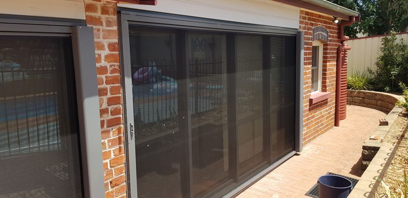 A Brick House With Sliding Glass Doors and a Patio — Kareela Constructions In Narrabri, NSW