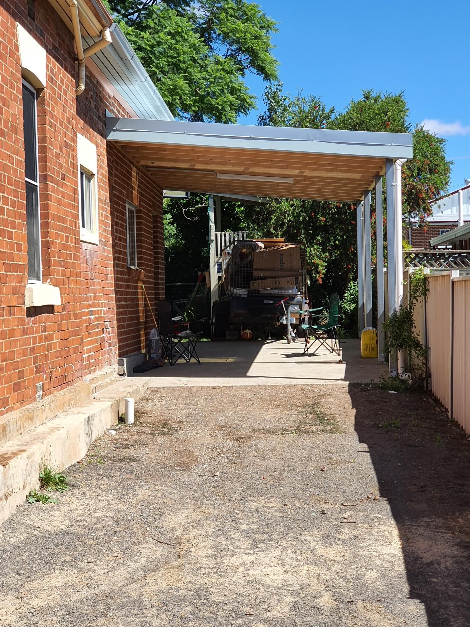 A Brick House With a Carport in Front of It — Kareela Constructions In Tamworth, NSW