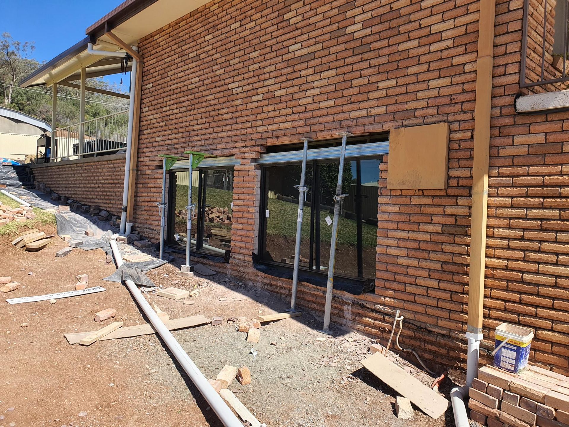 A Brick Building With a Lot of Windows is Being Built — Kareela Constructions In Tamworth, NSW