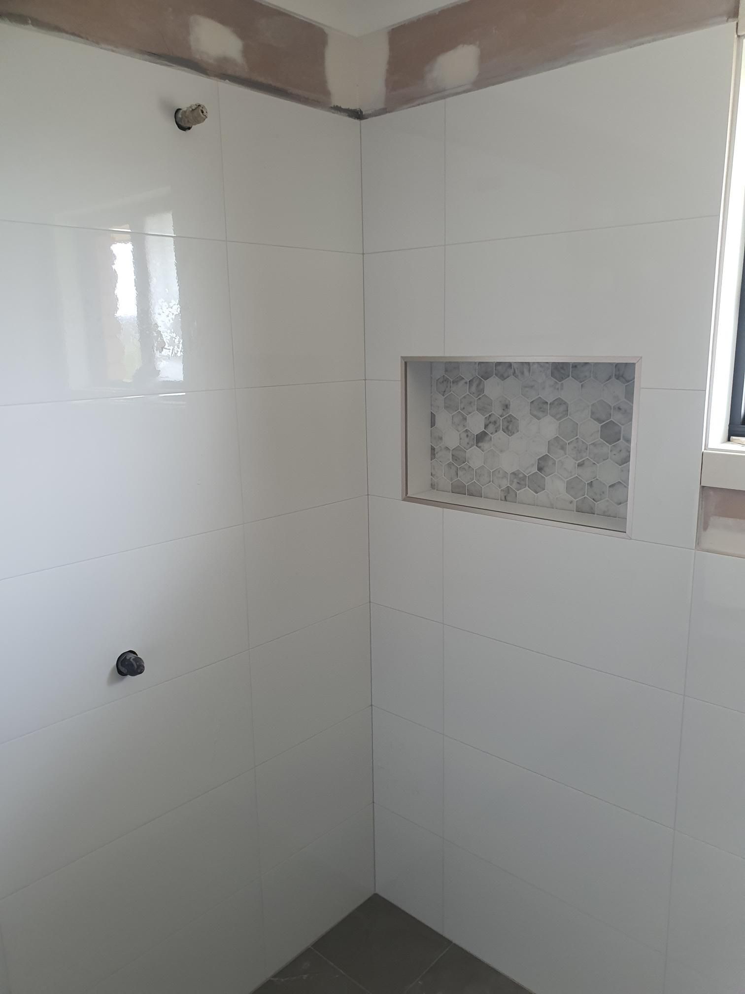 A Bathroom With White Tiles and a Niche in the Wall — Kareela Constructions In Tamworth, NSW