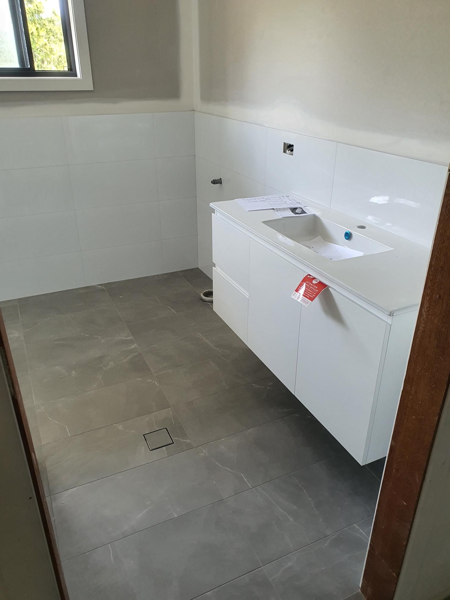 A Bathroom With a Sink and a Window — Kareela Constructions In Tamworth, NSW