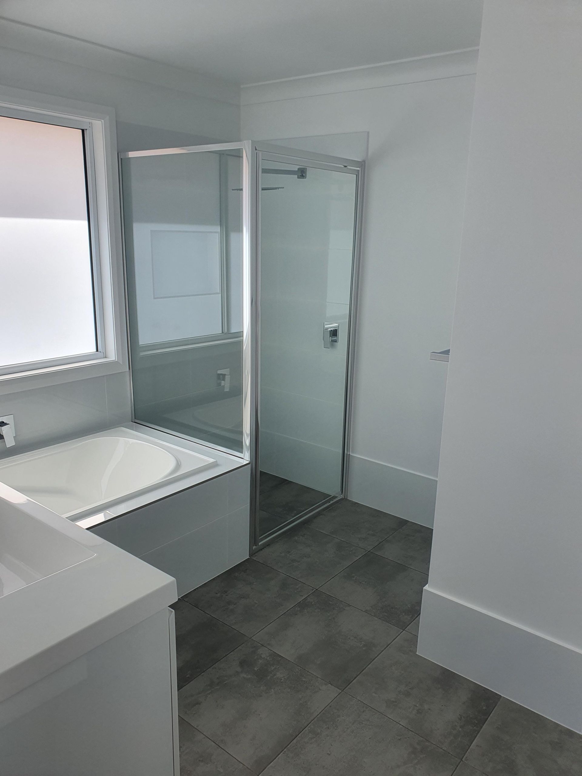 A Bathroom With a Bathtub and a Walk in Shower — Kareela Constructions In Tamworth, NSW