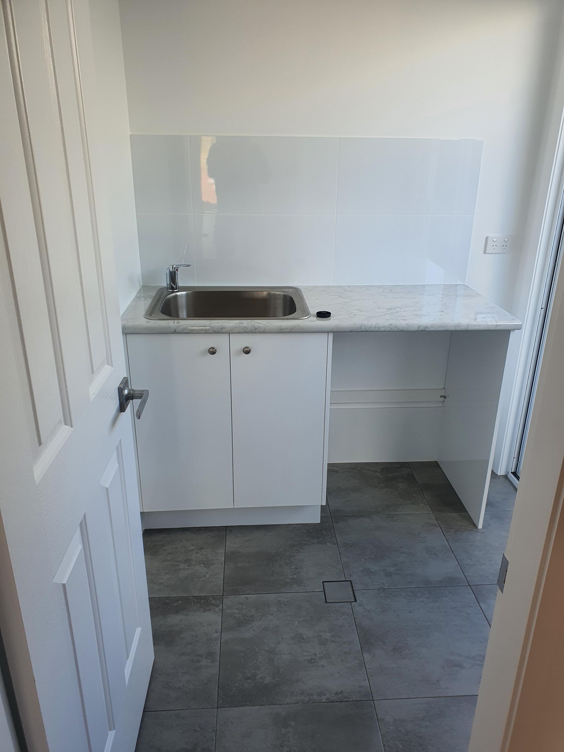 A Kitchen With White Cabinets, a Sink and a Counter Top — Kareela Constructions In Tamworth, NSW