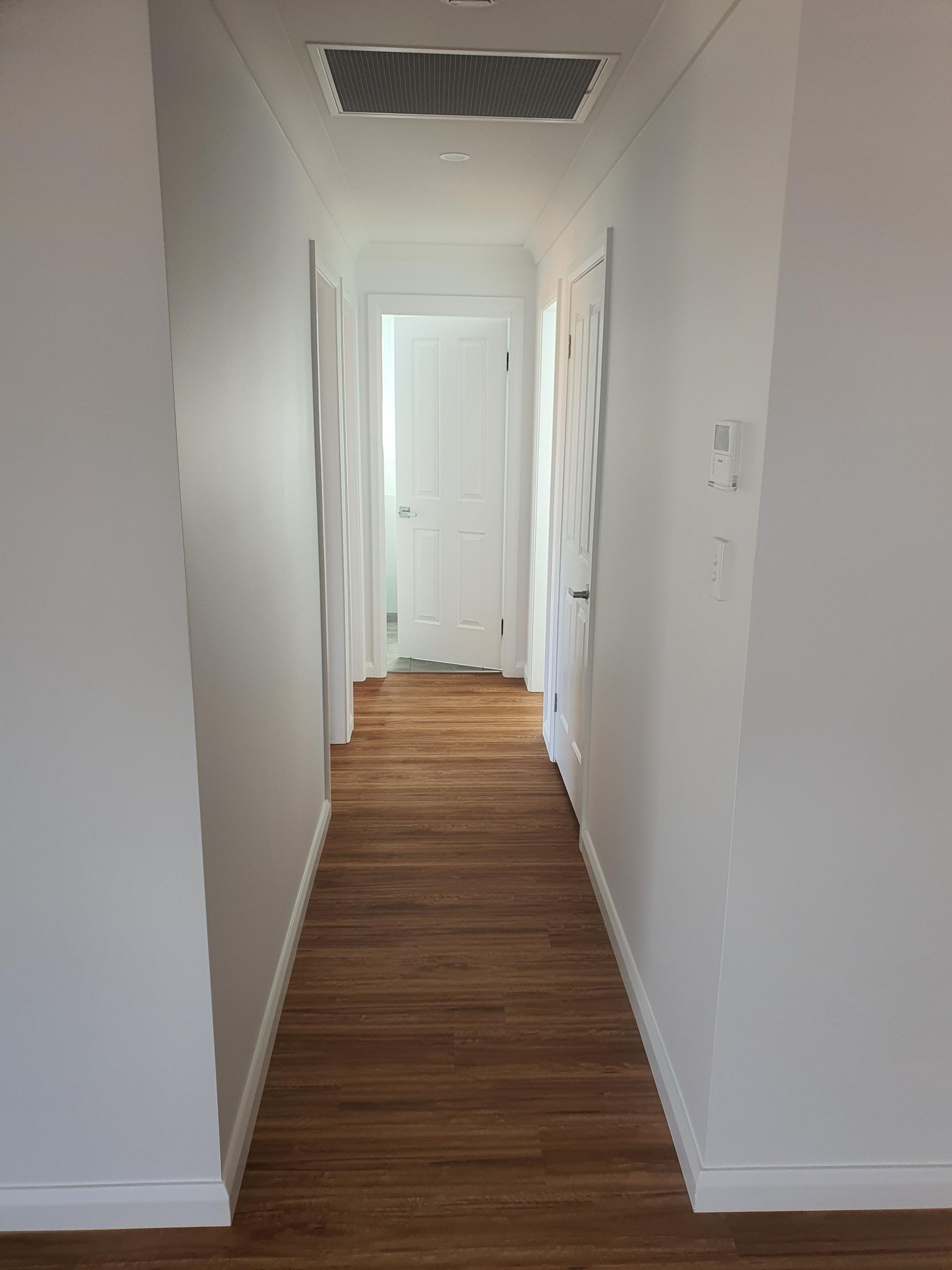 A Long Hallway With Wooden Floors — Kareela Constructions In Tamworth, NSW