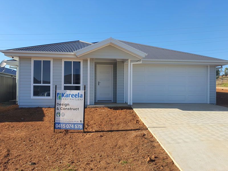 A White House With a Sign in Front of It — Kareela Constructions In Tamworth, NSW