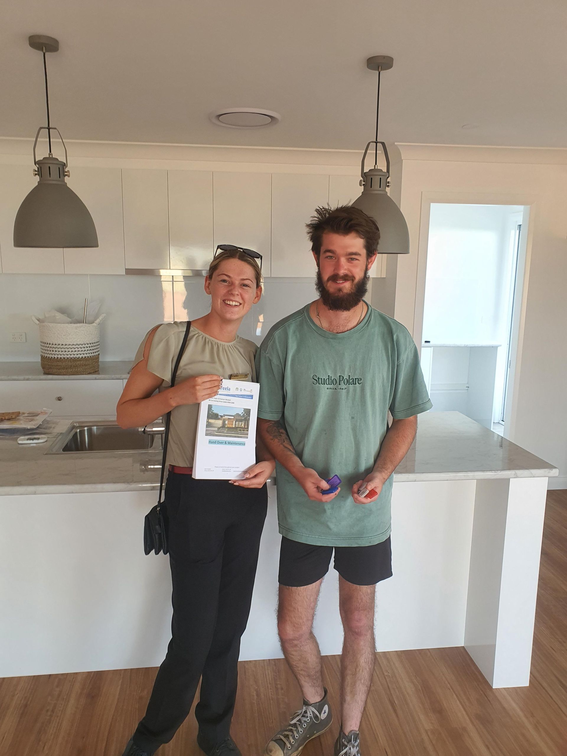 A Man and a Woman Are Standing in a Kitchen— Kareela Constructions In Tamworth, NSW