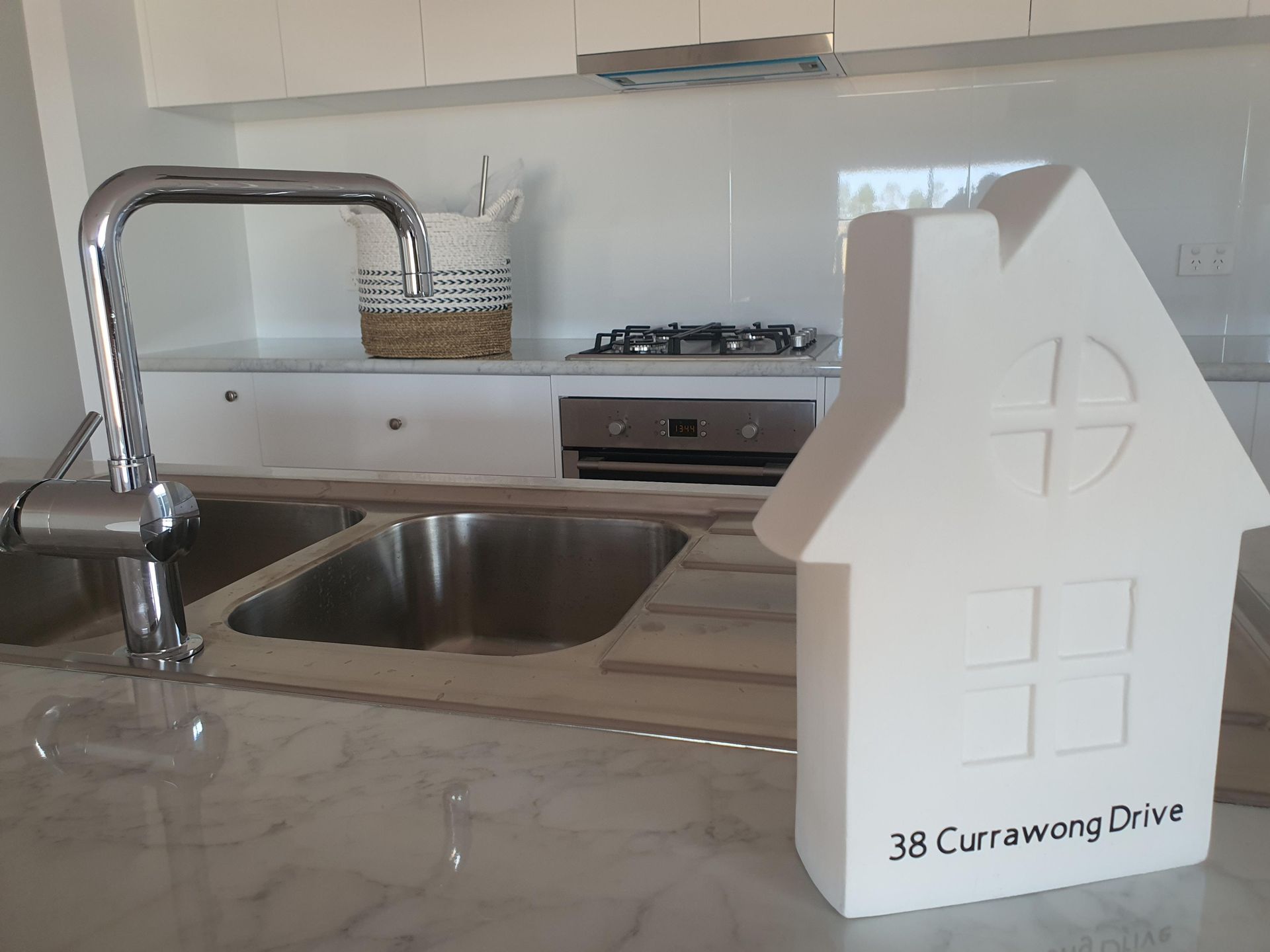 A kitchen with two sinks and a house shaped container — Kareela Constructions In Tamworth, NSW