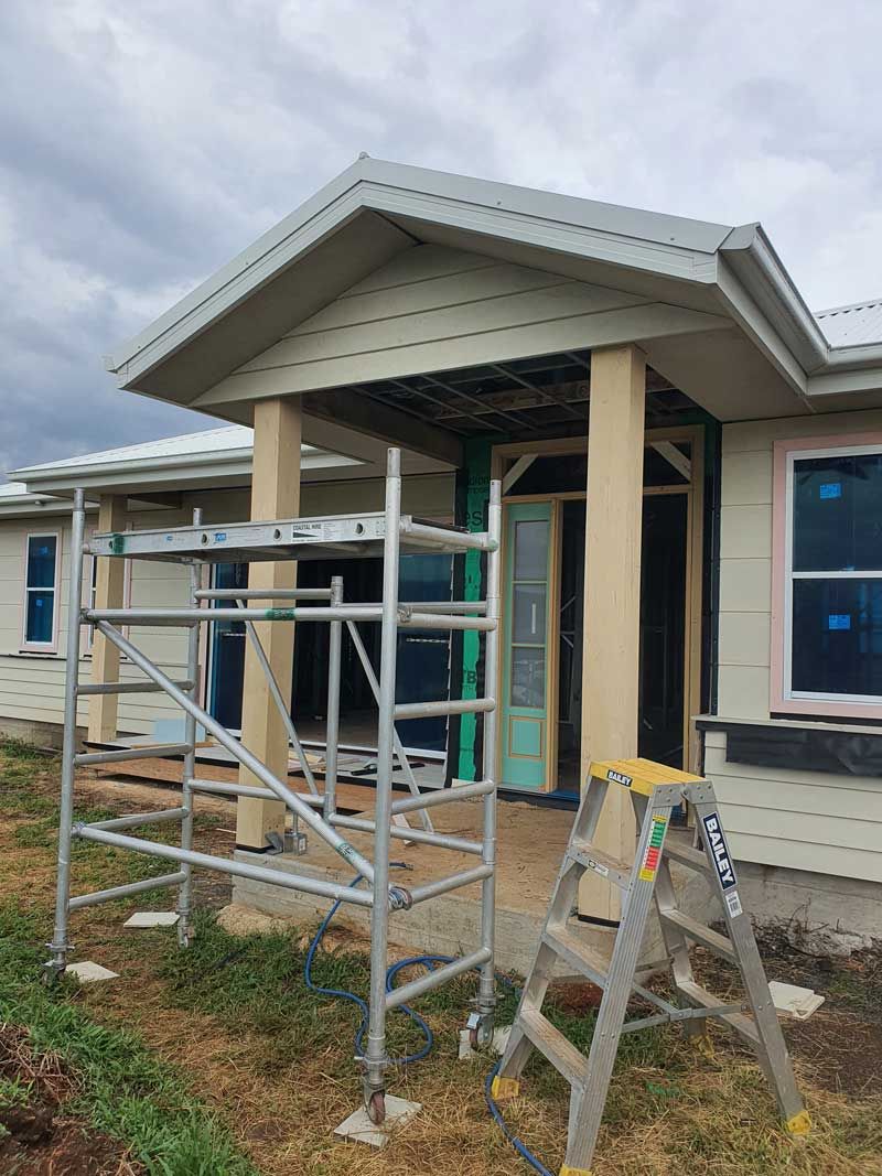 A House Under Construction With a Ladder and Scaffolding in Front of It — Kareela Constructions In Tamworth, NSW