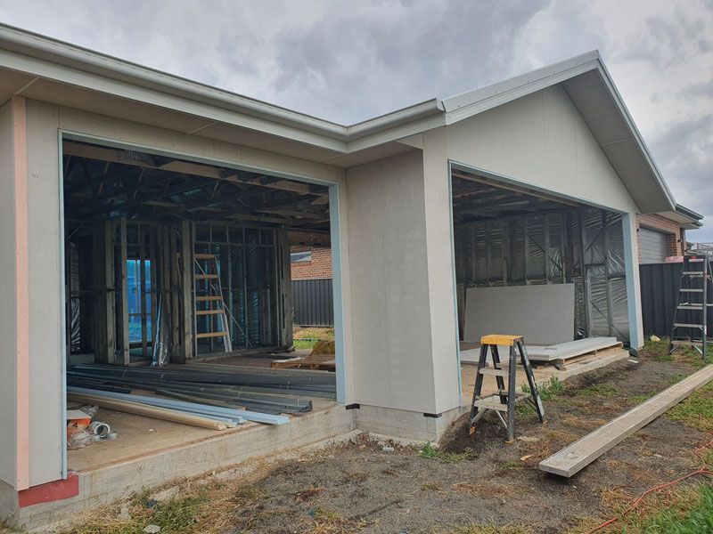 A House is Being Built With a Garage and a Ladder in the Backyard — Kareela Constructions In Tamworth, NSW