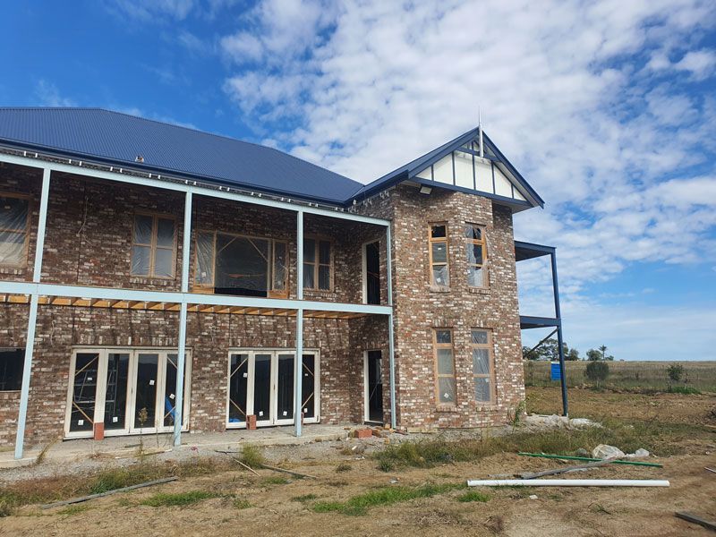 A Large Brick House is Being Built in a Field — Kareela Constructions In Gunnedah, NSW