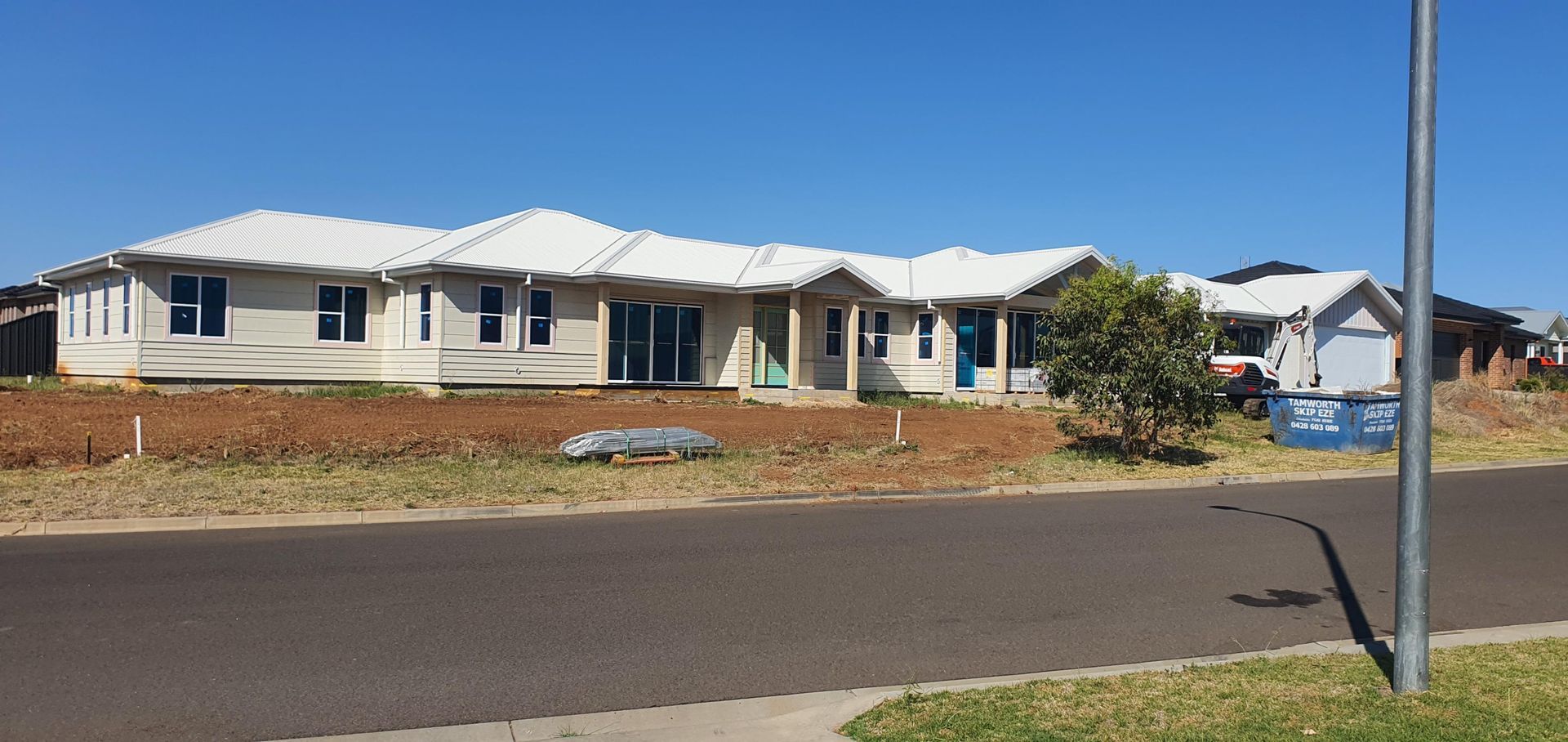 A Large White House is Being Built on the Side of the Road — Kareela Constructions In Tamworth, NSW