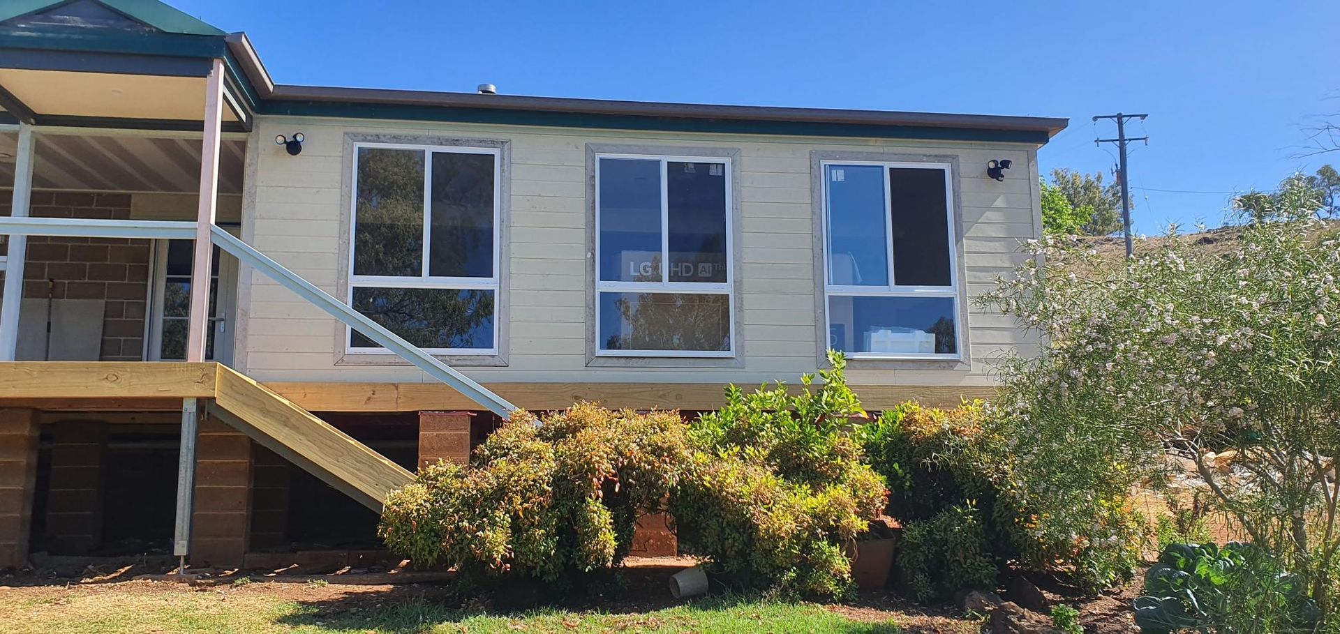A White House With a Lot of Windows and Stairs in Front of It — Kareela Constructions In Tamworth, NSW