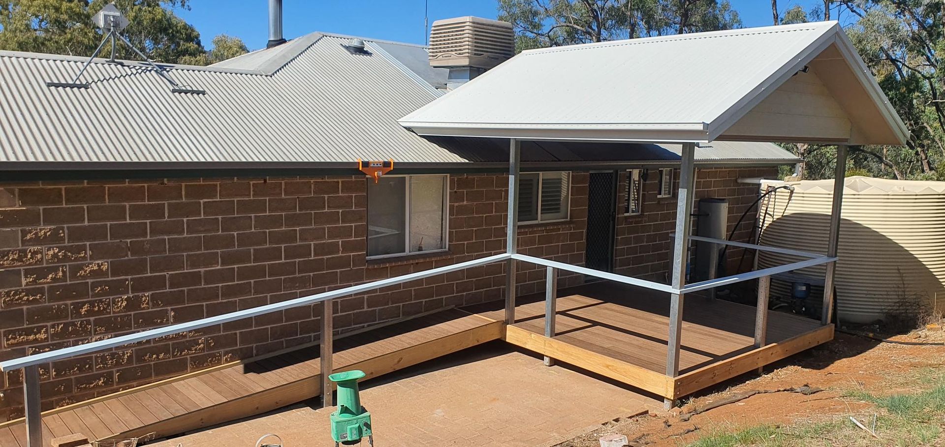 A Brick House With a Porch and a White Roof — Kareela Constructions In Tamworth, NSW