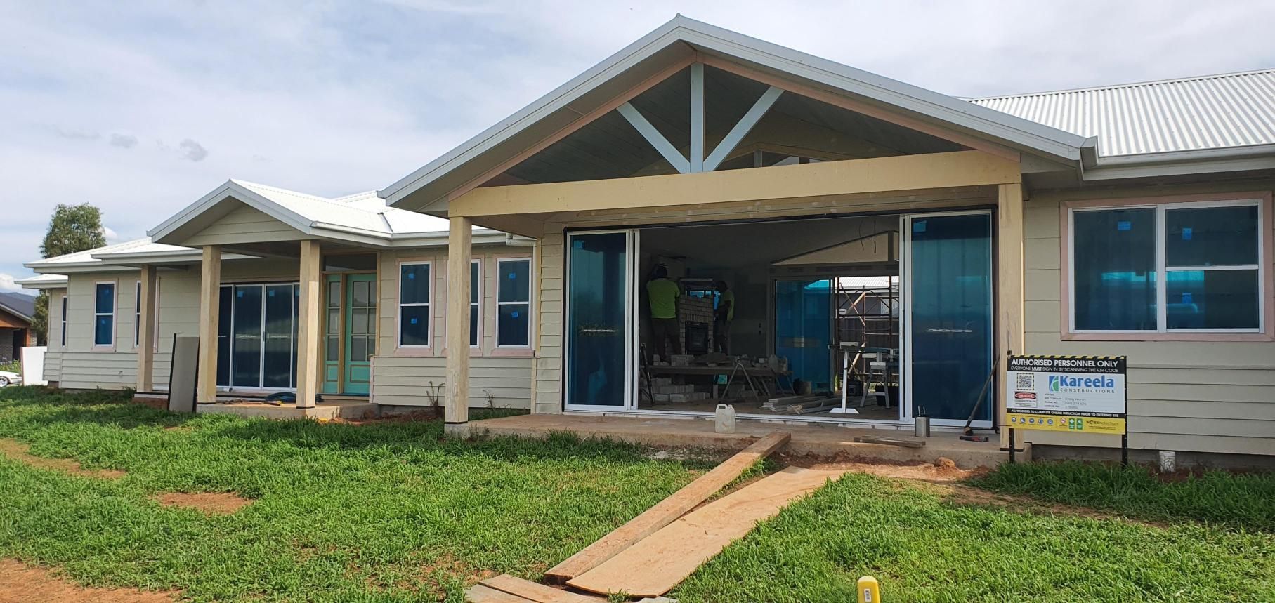 A House is Being Built in the Middle of a Grassy Field — Kareela Constructions In Tamworth, NSW