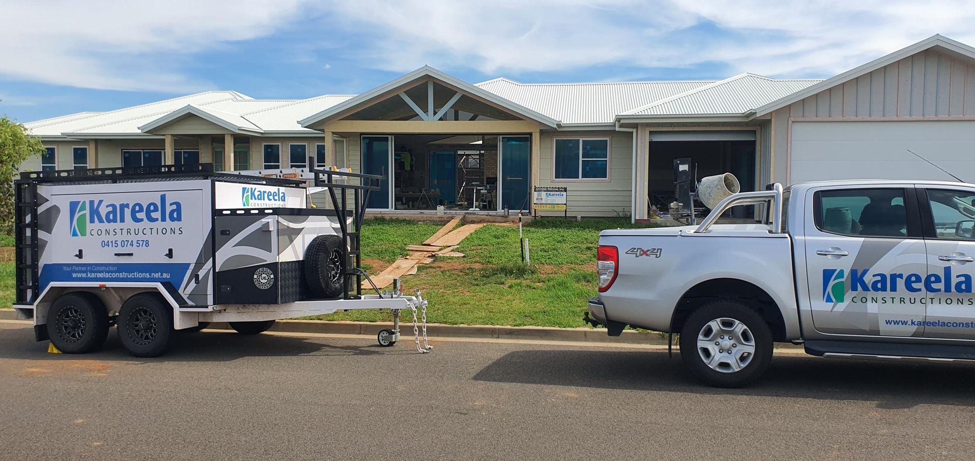 Two White Trucks Are Parked in Front of a House — Kareela Constructions In Tamworth, NSW