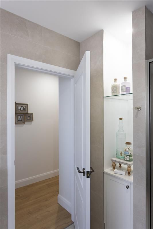 A White Door Leading To A Wooden Floored Walk Way- Kareela Constructions In Tamworth, NSW