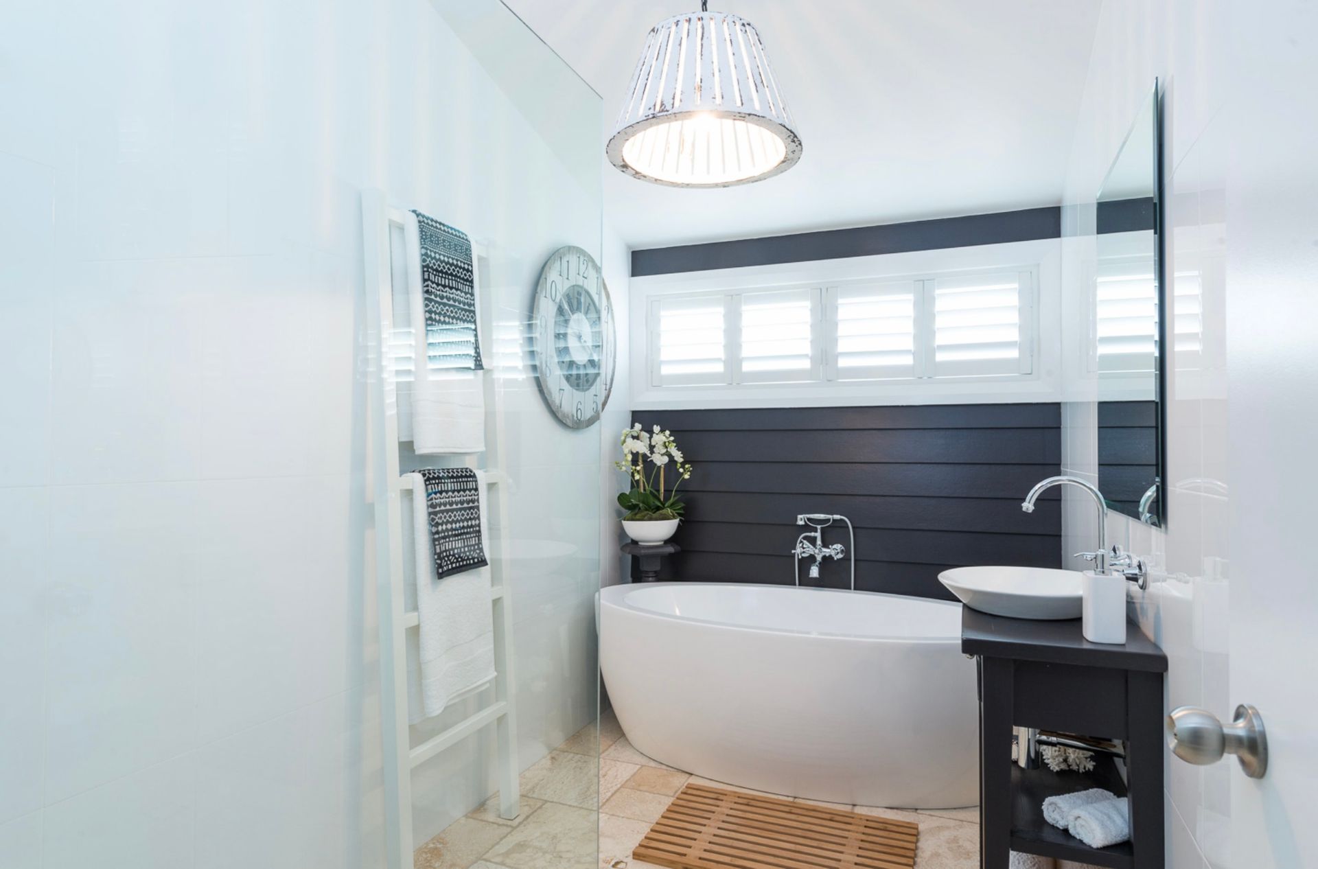 A Bathroom With a Bathtub, Sink and Mirror — Kareela Constructions In Tamworth, NSW