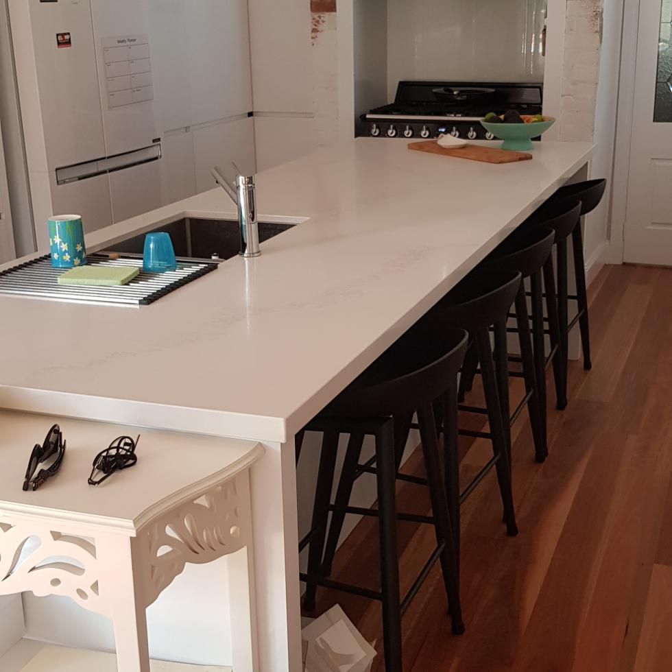 A Kitchen With a White Counter Top and Black Stools — Kareela Constructions In Tamworth, NSW