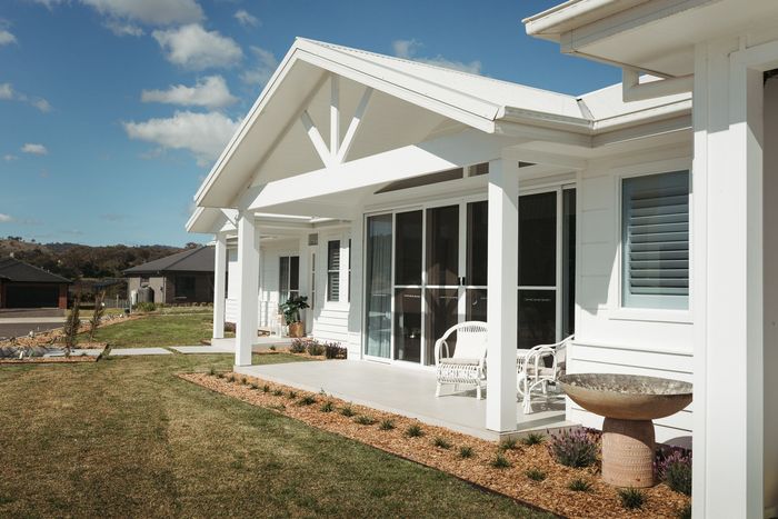 White house with porch and lawn; clear blue sky. — Kareela Constructions In Tamworth, NSW