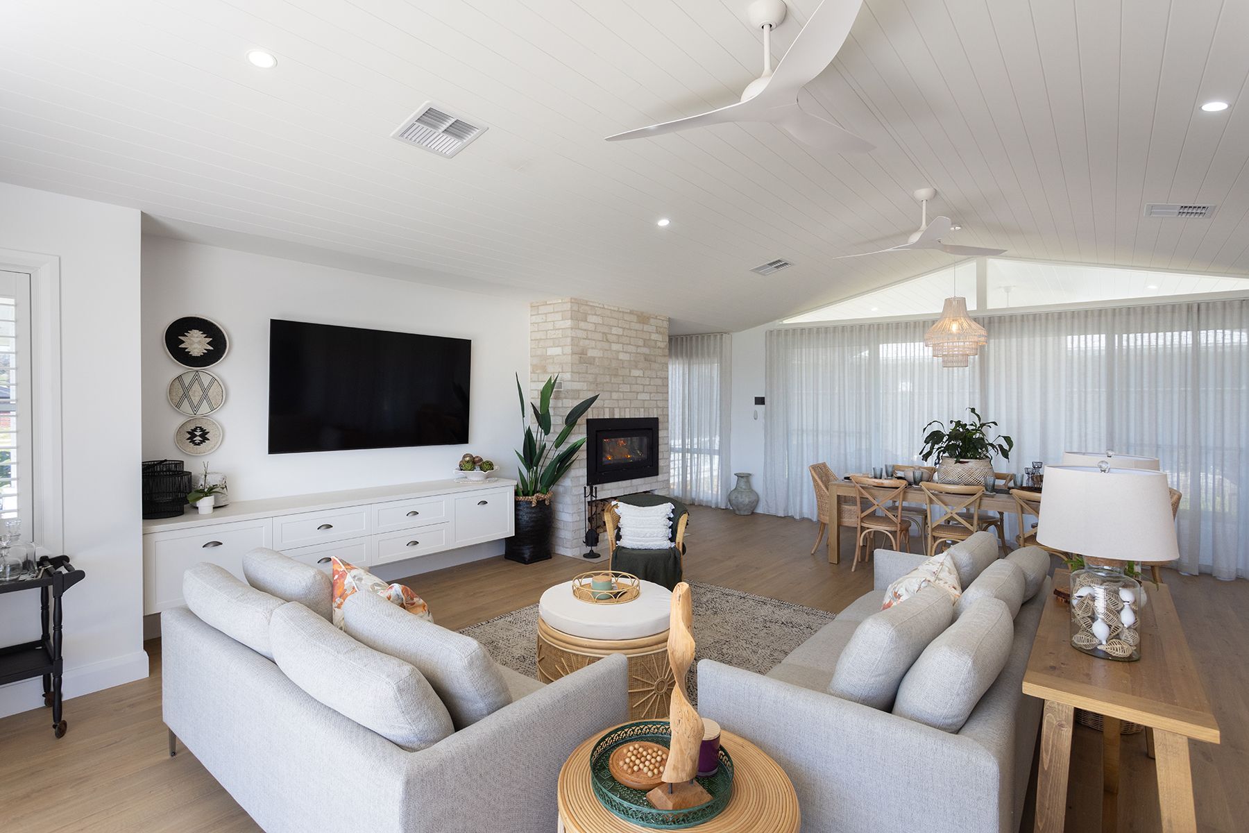 ALiving Room With White Walls and Couches, and Cream Coloured Decorations in NSW