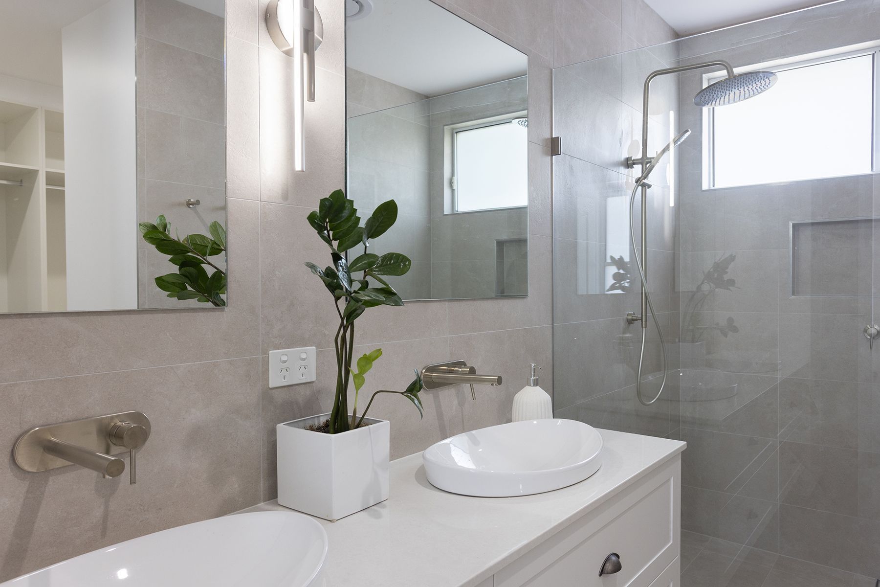 A Bathroom With a Sink, Mirror and Towel Hanging on the Wall — Kareela Constructions In Tamworth, NSW