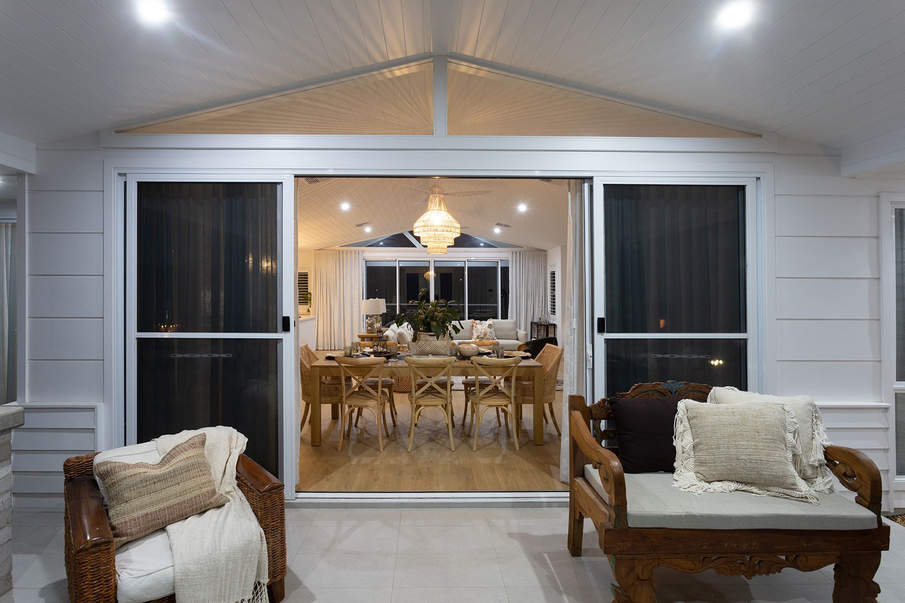 A Patio With a Table and Chairs and Mountains in the Background — Kareela Constructions In Tamworth, NSW