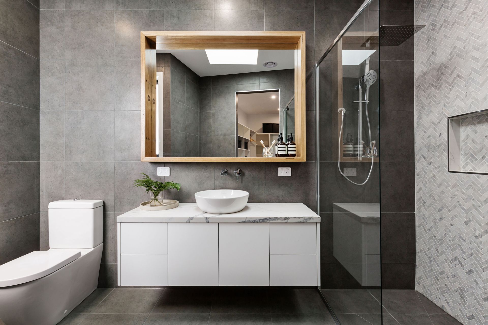 Modern bathroom renovation with timber vanity, shower and efficient fixtures for sustainable use