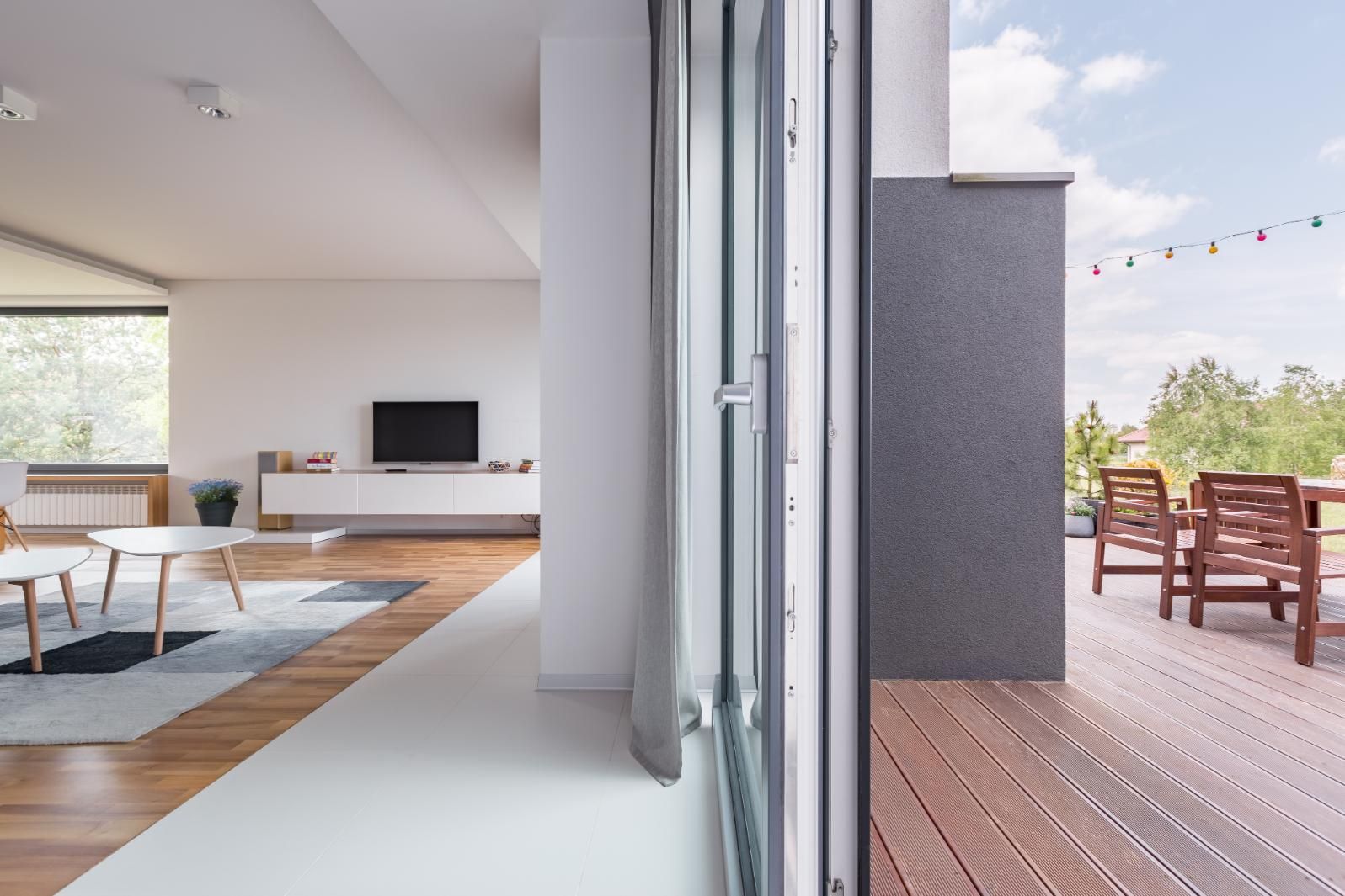 A Living Room With a Sliding Glass Door Leading to a Balcony — Kareela Constructions In Tamworth, NSW