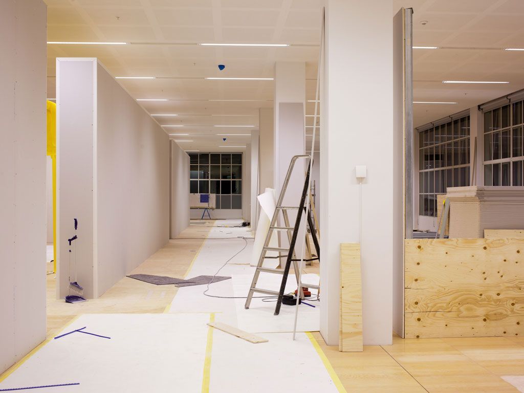 Industrial Electrical Contractor - A ladder is sitting in a hallway of a building under construction.