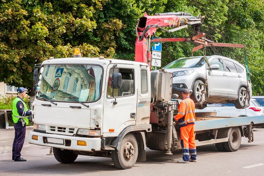 A Tow Truck is Towing a Car on the Back of It — Tow Biz in Gracemere, QLD