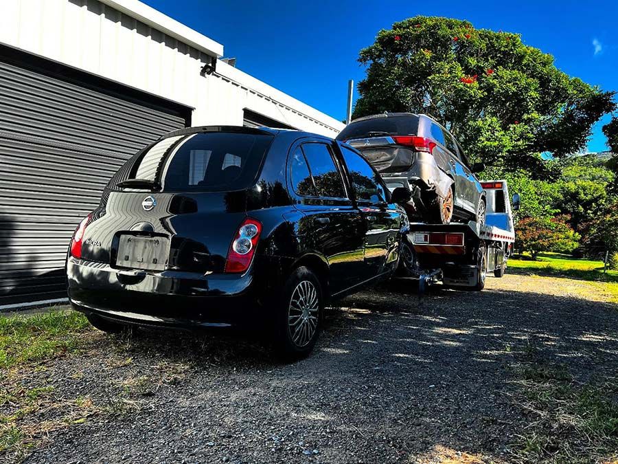 A Black Car is Being Towed by a Tow Truck — Tow Biz in Park Avenue, QLD