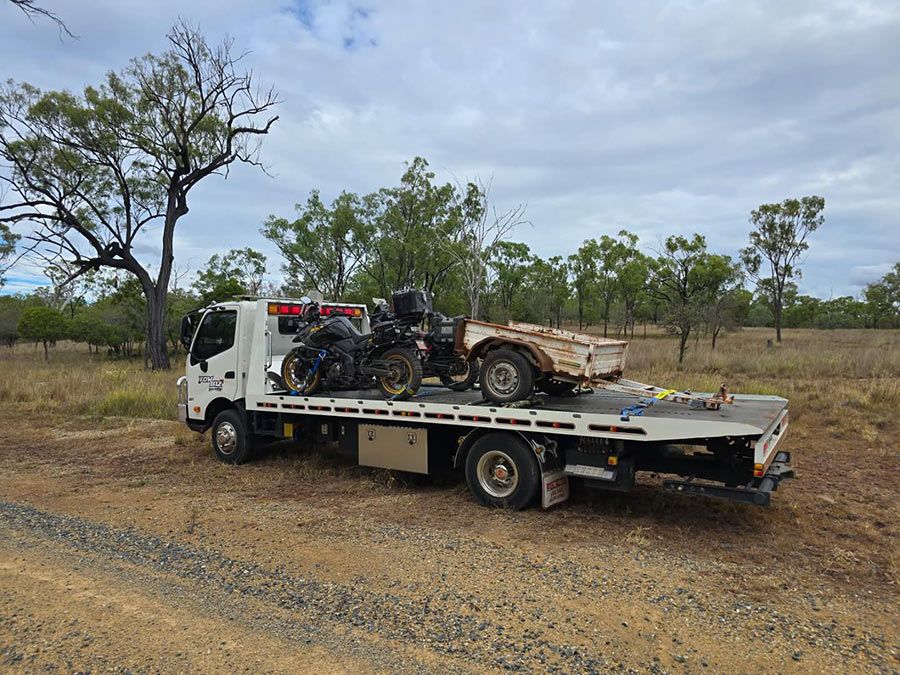 A Tow Truck is Carrying a Motorcycle and a Car on the Back of It — Tow Biz in Park Avenue, QLD