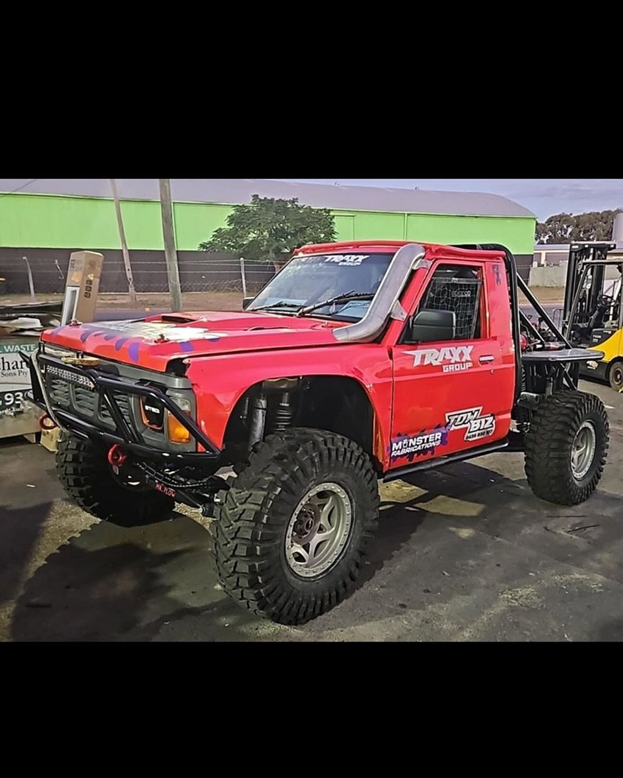A Red Truck is Parked in a Parking Lot Next to a Forklift — Tow Biz in Park Avenue, QLD