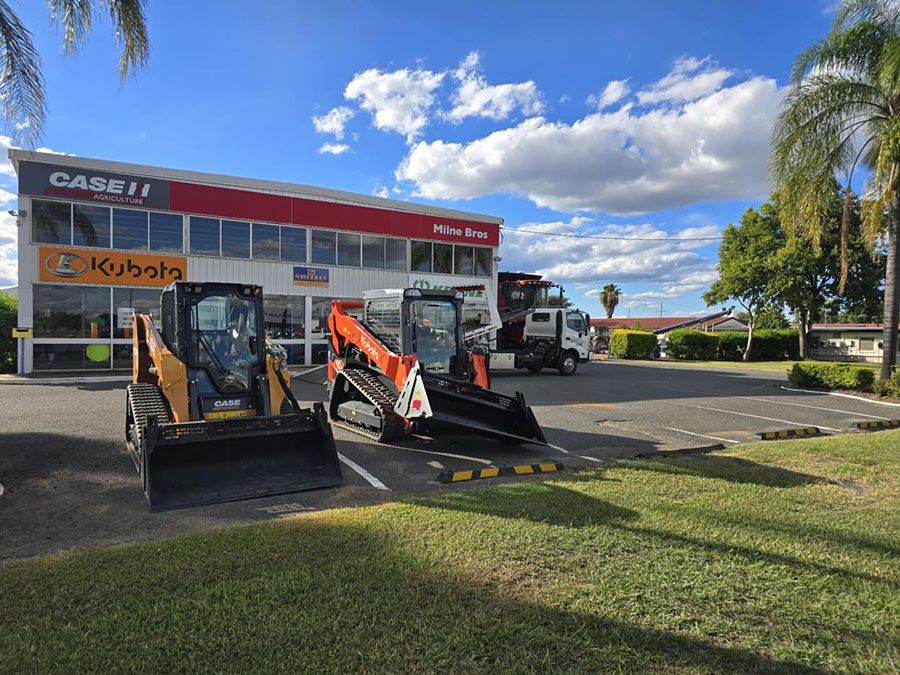 A Couple of Tractors Are Parked in Front of a Building — Tow Biz in Park Avenue, QLD