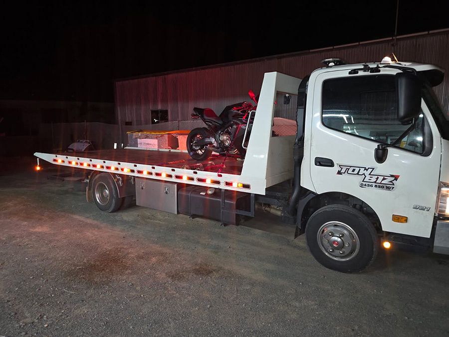 A Tow Truck With a Motorcycle on the Back of It — Tow Biz in Park Avenue, QLD