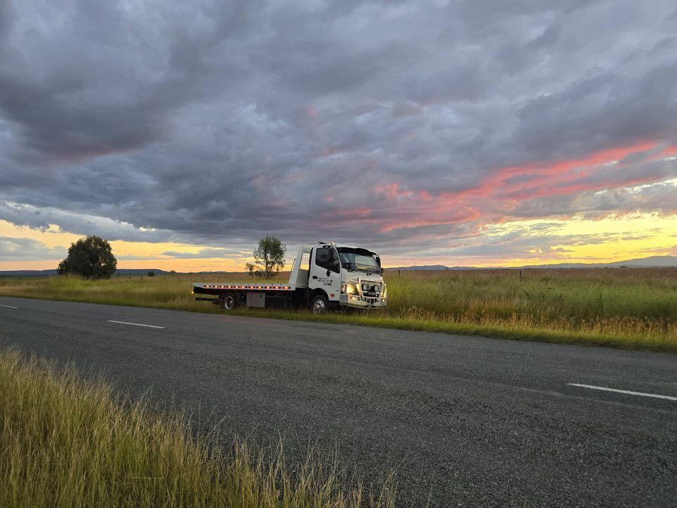 A Tow Truck is Parked on the Side of a Road in a Field — Tow Biz in Gracemere, QLD