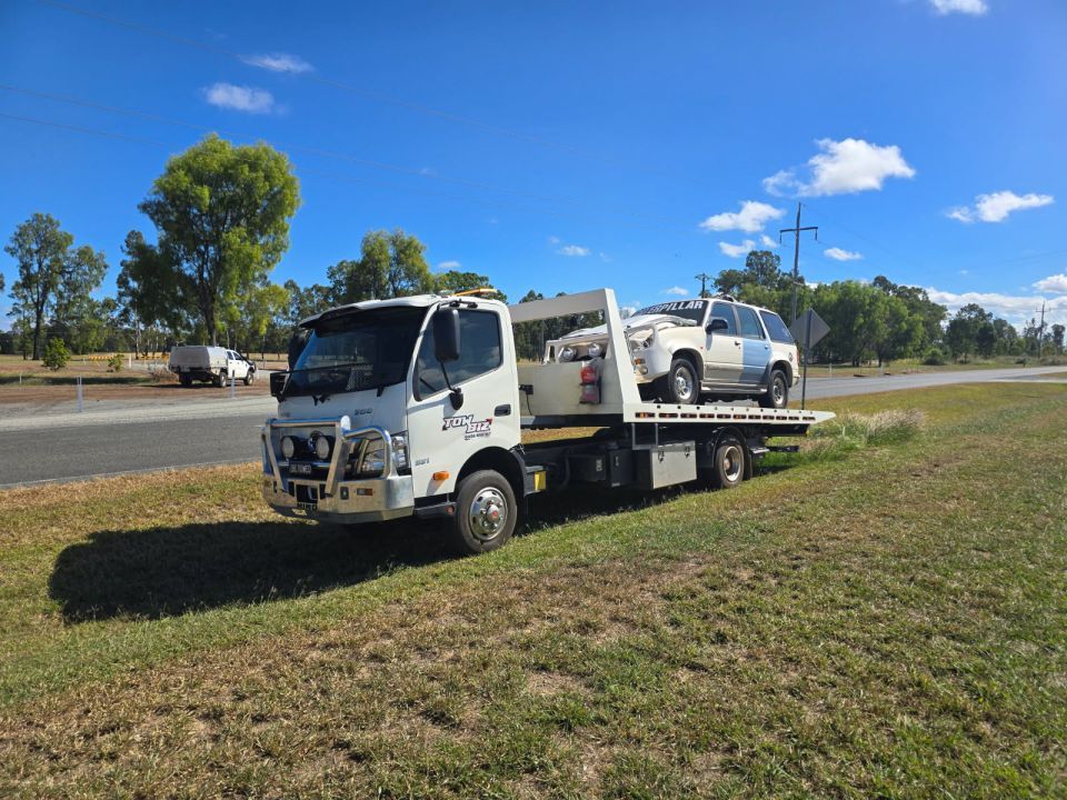 A Tow Truck is Carrying a Car on the Back of It — Tow Biz in Park Avenue, QLD