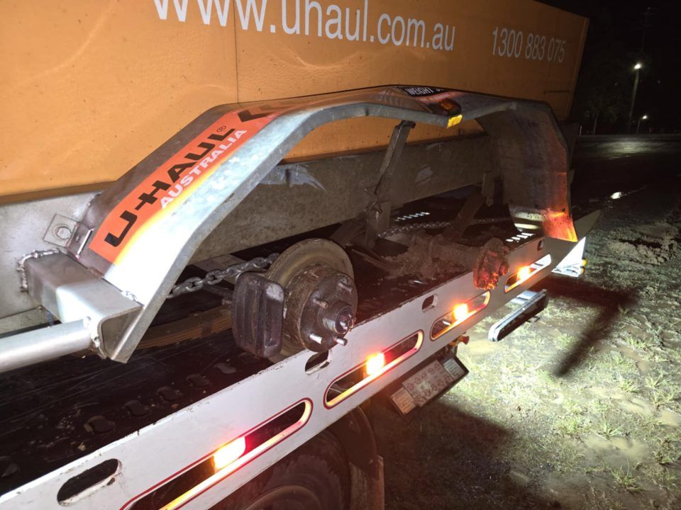 A Uhaul Tow Truck With a Broken Wheel — Tow Biz in Yeppoon, QLD