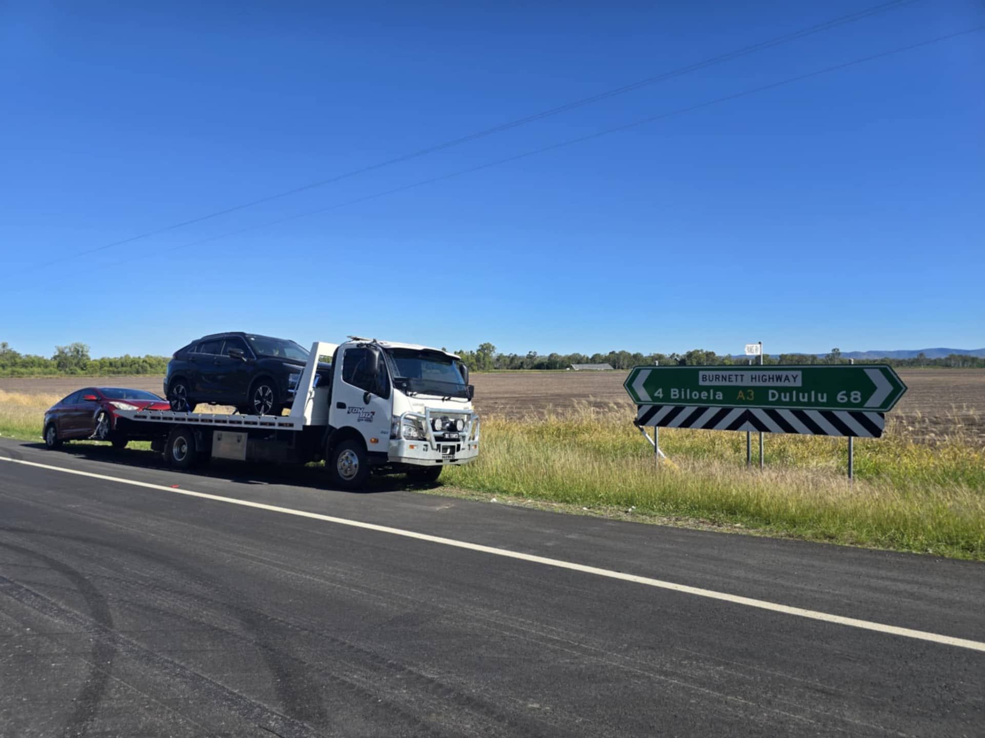 A Tow Truck is Towing a Car on the Side of the Road — Tow Biz in Park Avenue, QLD