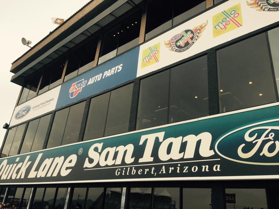 Building with logos for NAPA Auto Parts, Quick Lane, and Ford, located in Gilbert, Arizona.