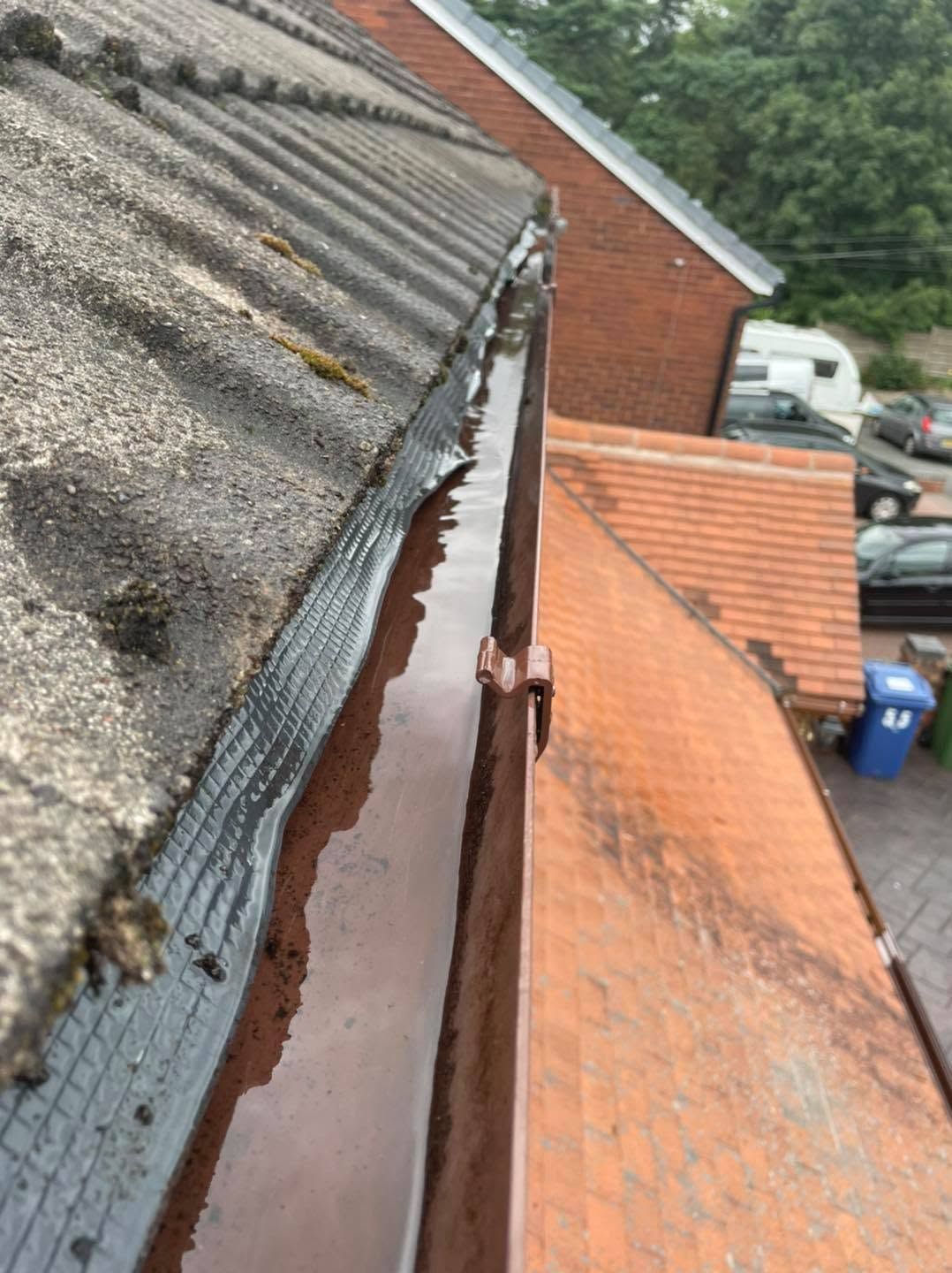 Brown gutter in Penn after removal of moss, leaves and debris