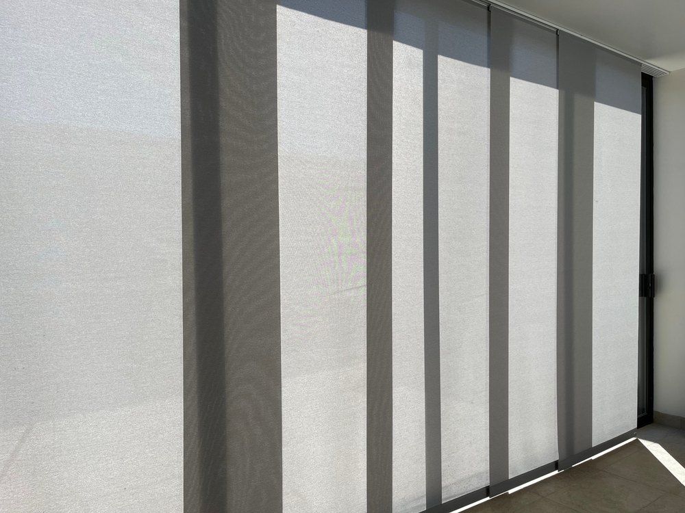 Gray Vertical Blinds Covering a Window — Glenn Koek - Shutters - Curtains - Blinds in West Wollongong, NSW