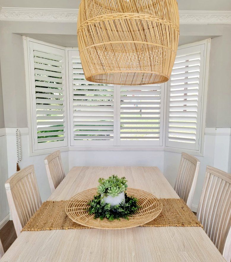 Dining Room With a Window Features White Shutters — Glenn Koek - Shutters - Curtains - Blinds in West Wollongong, NSW