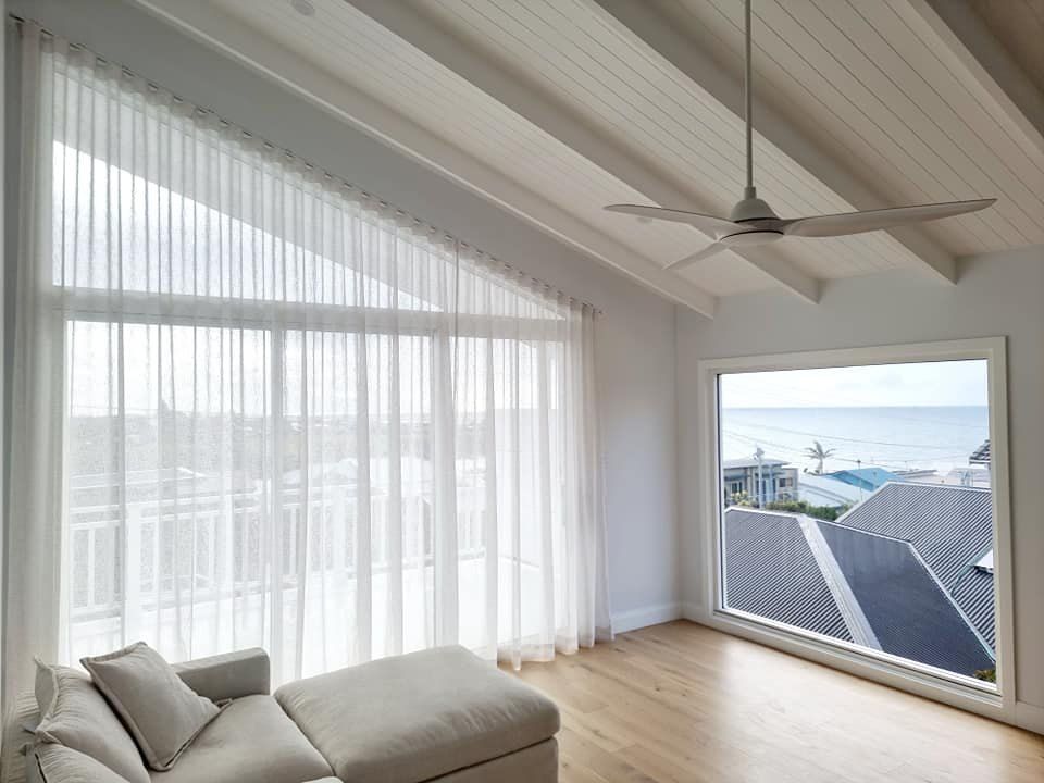 Bright, Airy Room With Sheer Curtains Over Large Windows — Glenn Koek - Shutters - Curtains - Blinds in West Wollongong, NSW